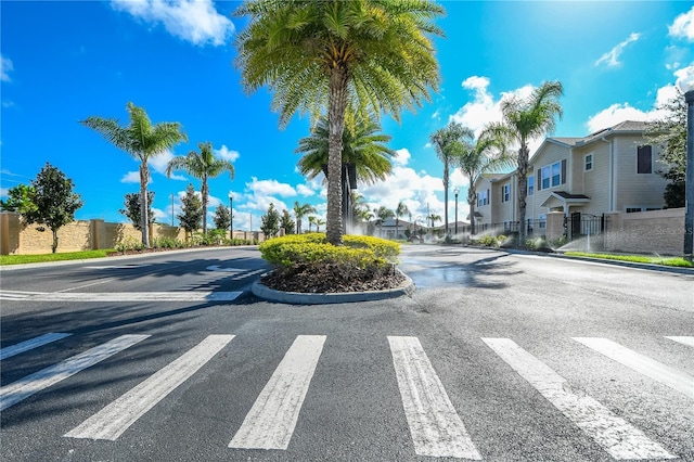 view of road with a residential view and curbs