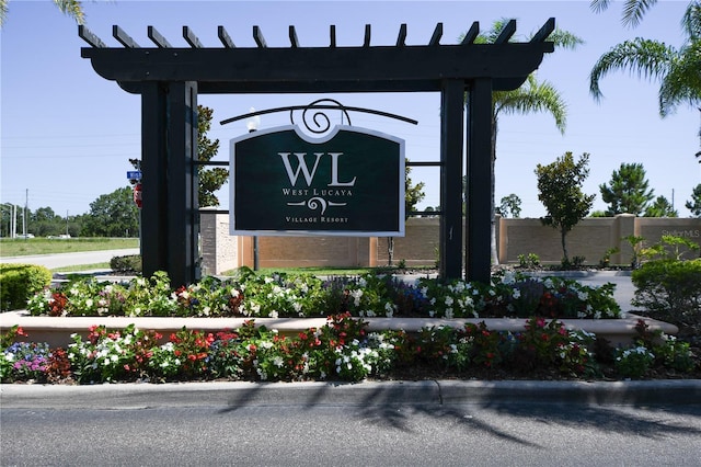 community / neighborhood sign with fence