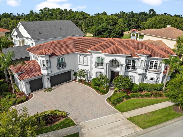 mediterranean / spanish home with a garage