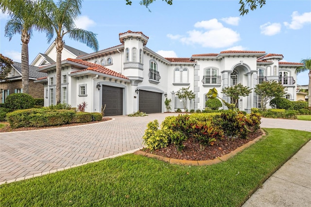 mediterranean / spanish home with a garage and a front lawn