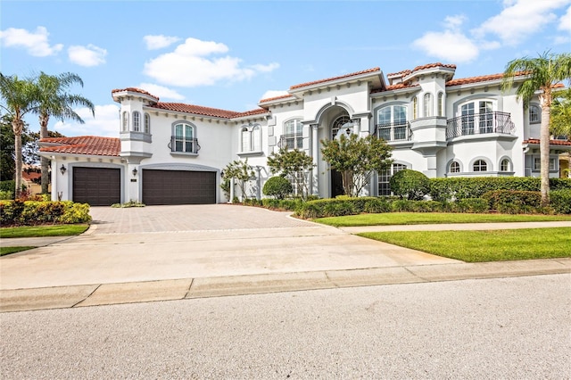 mediterranean / spanish house with a garage and a front yard