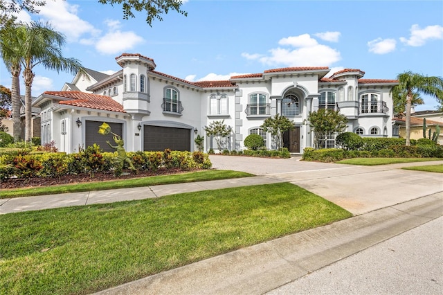 mediterranean / spanish house with a balcony and a front lawn