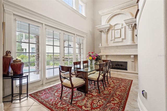 tiled dining room with a premium fireplace and a wealth of natural light