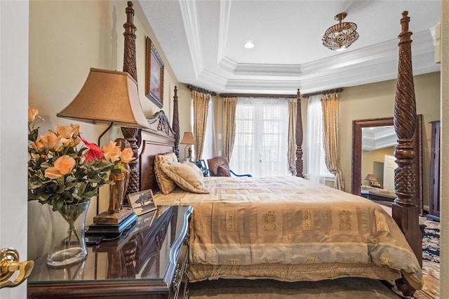 bedroom with crown molding and a raised ceiling