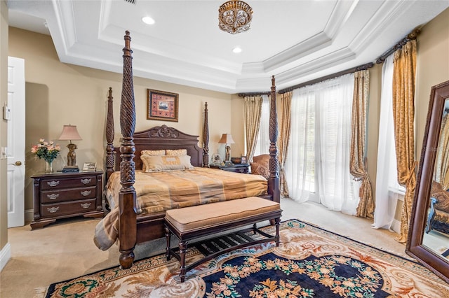 carpeted bedroom featuring ornamental molding and a tray ceiling