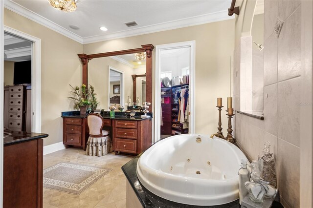 bathroom with ornamental molding, vanity, and tiled tub