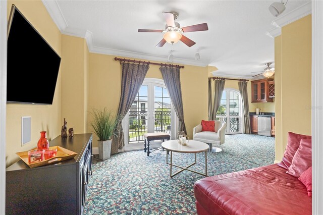 carpeted living room with ceiling fan and ornamental molding