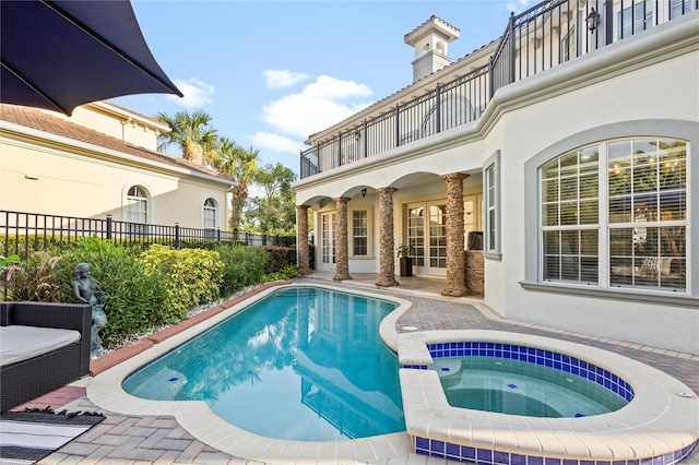 view of pool with an in ground hot tub and a patio