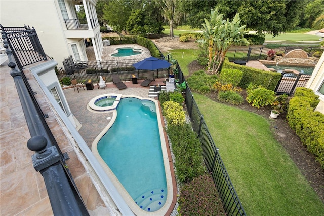 view of pool featuring a patio area and an in ground hot tub