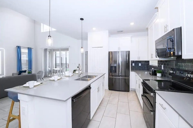 kitchen featuring white cabinetry, sink, a center island with sink, and black appliances