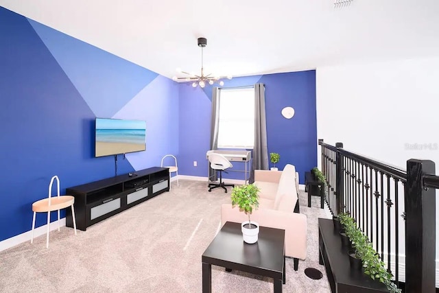 living room with carpet floors and a notable chandelier