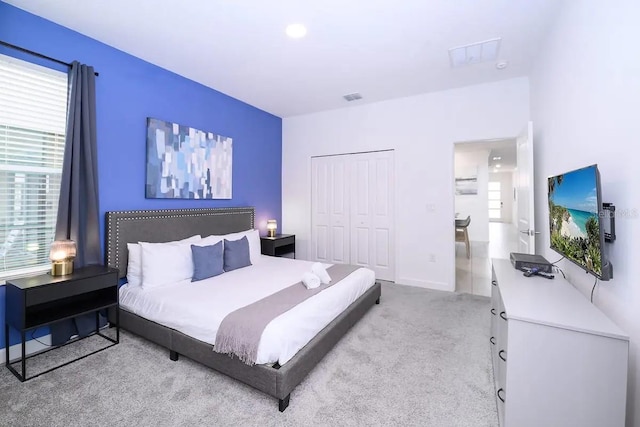 carpeted bedroom featuring a closet