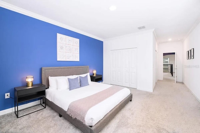 carpeted bedroom featuring a closet and ornamental molding