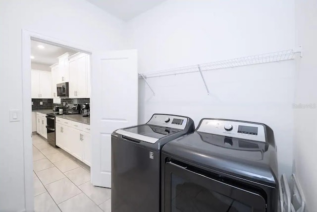 laundry area featuring light tile patterned flooring and washer and dryer