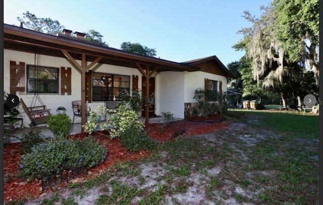 back of house with a lawn