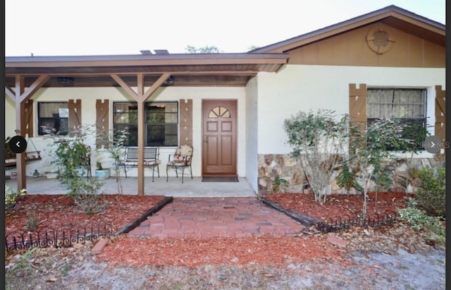 property entrance with a patio