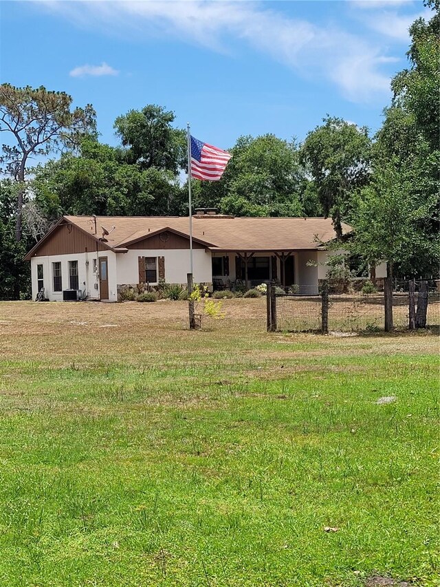 rear view of house with a lawn