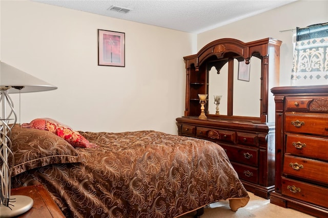 bedroom featuring carpet and a textured ceiling