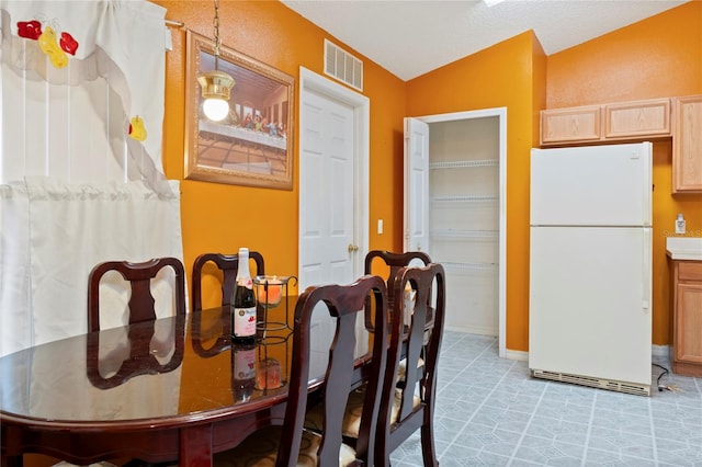 dining room featuring vaulted ceiling