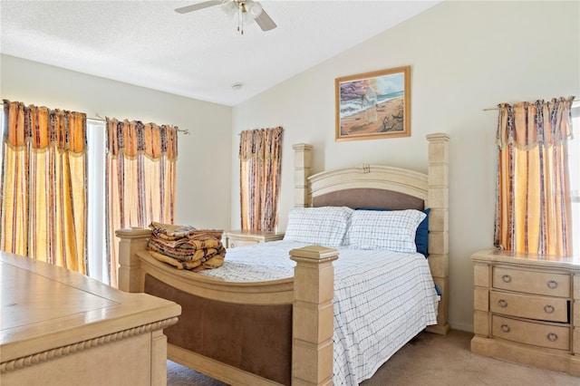 bedroom featuring ceiling fan, light colored carpet, a textured ceiling, and lofted ceiling