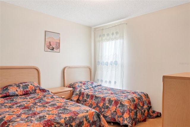 carpeted bedroom featuring a textured ceiling