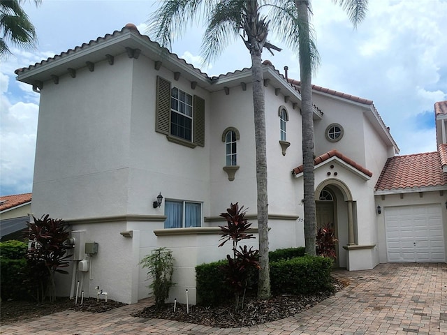 mediterranean / spanish-style house featuring a garage