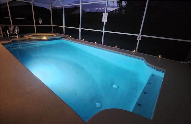 view of swimming pool with an in ground hot tub and glass enclosure