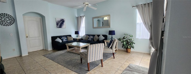 living room featuring a wealth of natural light, ceiling fan, and light tile patterned flooring