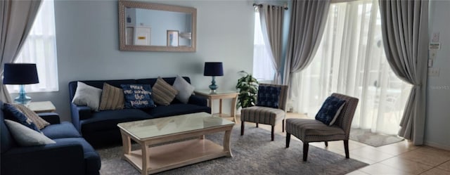 living room with light tile patterned flooring and a healthy amount of sunlight