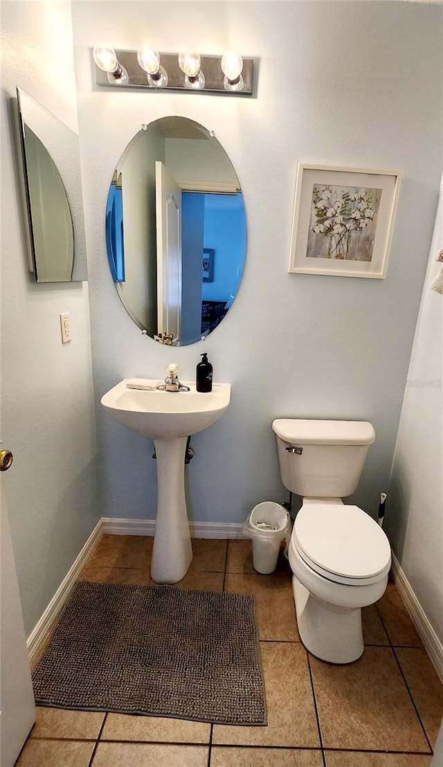 bathroom featuring tile patterned flooring and toilet