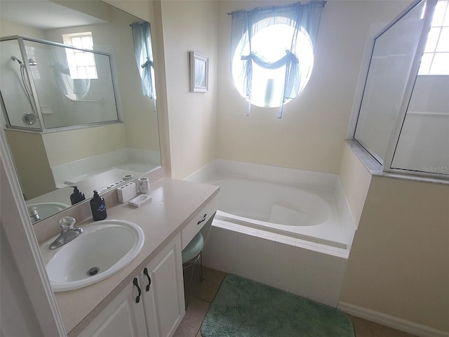 bathroom featuring tile patterned flooring, vanity, and shower with separate bathtub