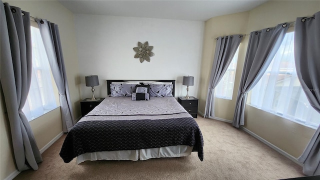 bedroom with carpet floors and multiple windows