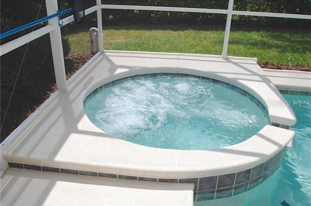 view of pool with an in ground hot tub