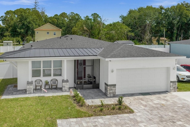 rear view of property with a lawn and a garage