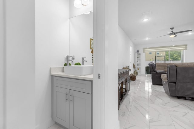 bathroom with ceiling fan and sink