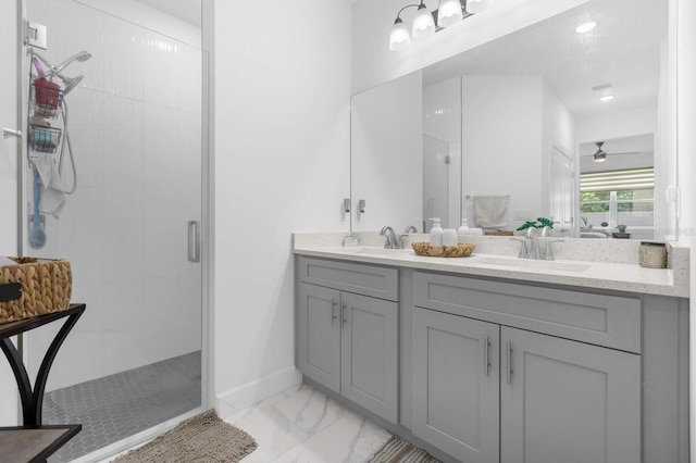 bathroom featuring vanity, ceiling fan, and a shower with shower door