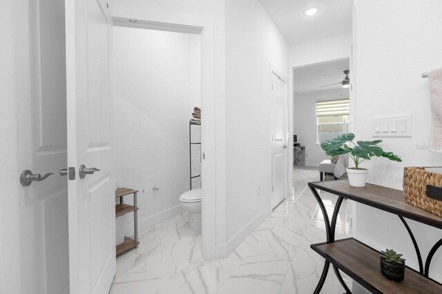 bathroom featuring ceiling fan and toilet