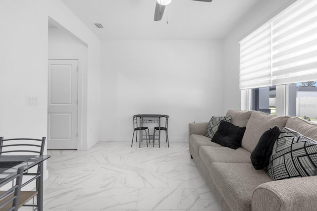 living room with a wealth of natural light and ceiling fan