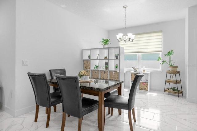 dining space with a chandelier and a textured ceiling