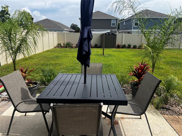 view of patio with a storage unit