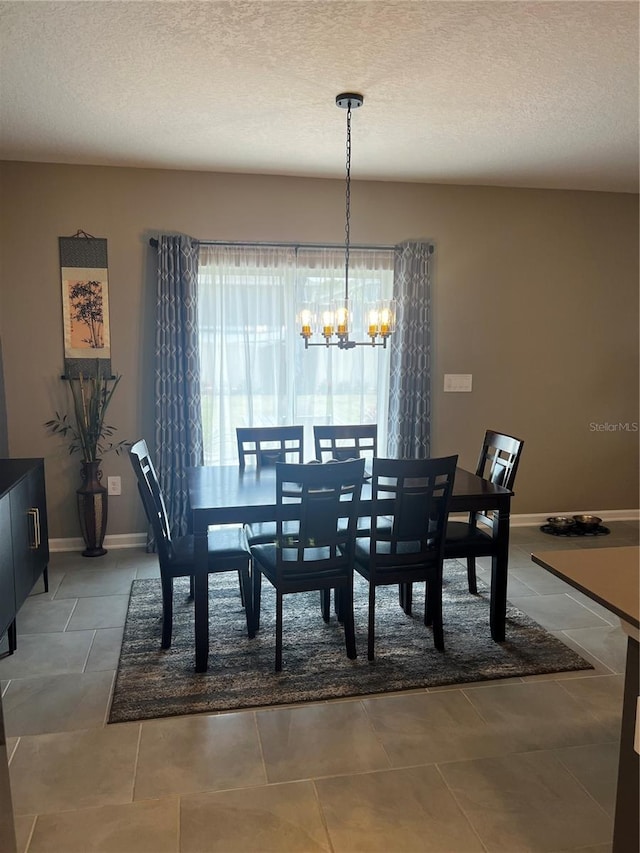 dining area with a textured ceiling and a notable chandelier