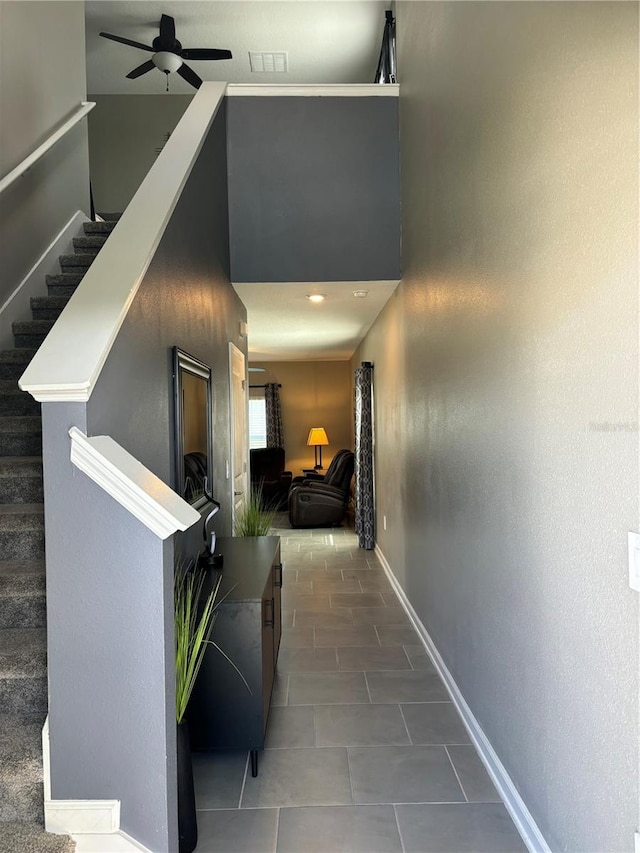 hall with dark tile patterned floors