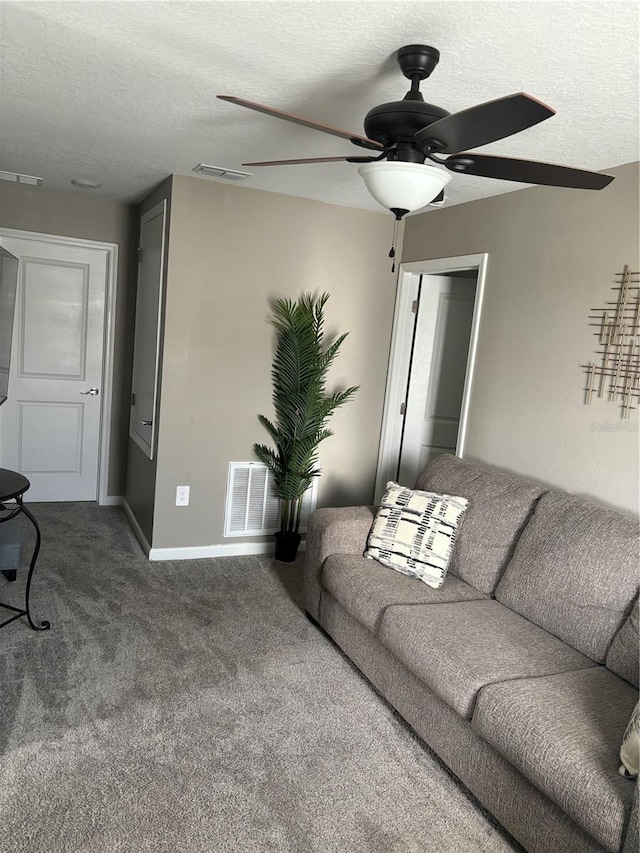 living room featuring ceiling fan, a textured ceiling, and carpet floors