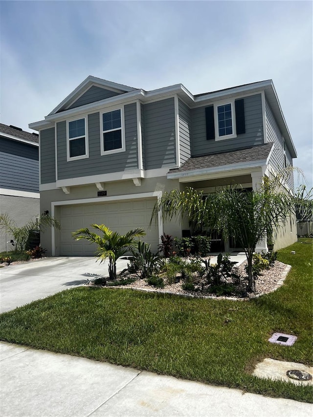 view of front facade with a garage and a front lawn