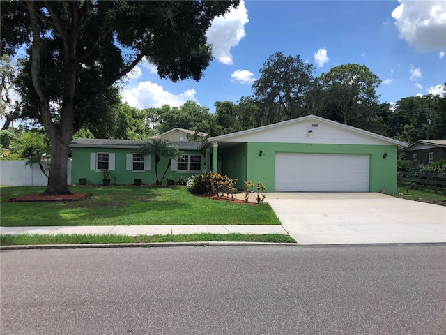 single story home featuring a garage and a front yard