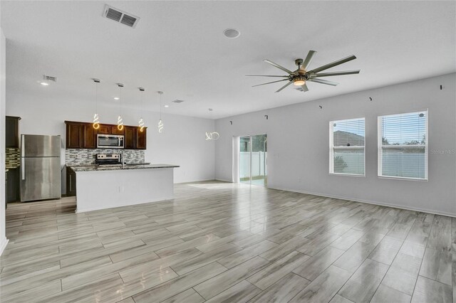 unfurnished living room featuring ceiling fan and light wood-type flooring