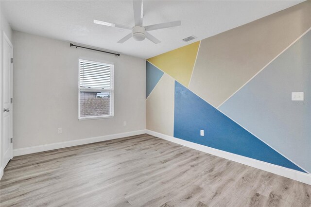 unfurnished room with ceiling fan and light hardwood / wood-style floors