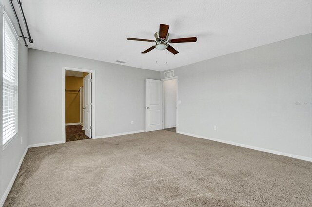 interior space featuring carpet and ceiling fan