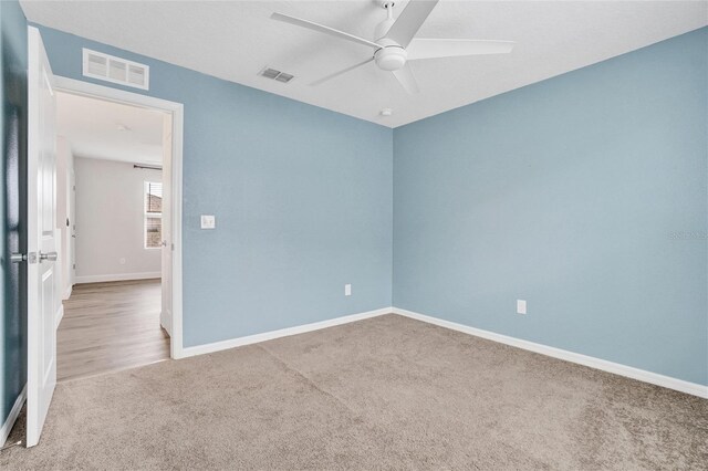 empty room featuring carpet floors and ceiling fan