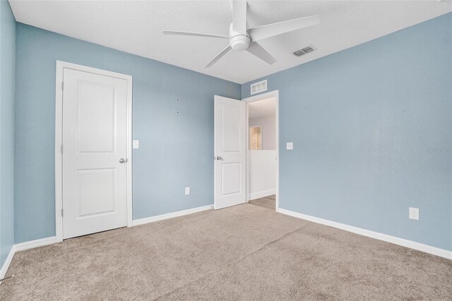 carpeted empty room with ceiling fan